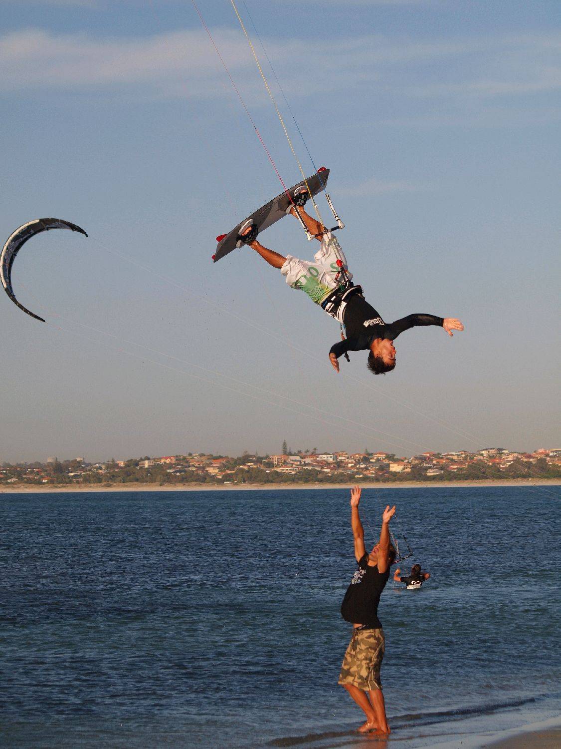 Simon Deadman over dude on beach
