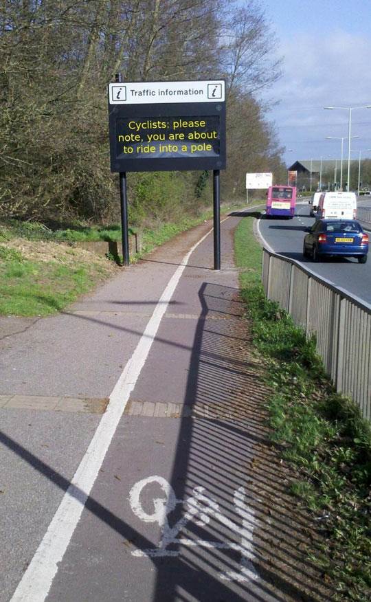 funny-sign-cyclists-ride-pole-street
