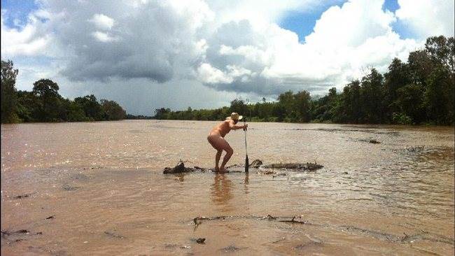 136650-nakes-man-on-log-on-daly-river
